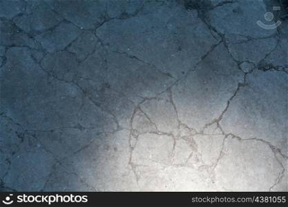 obsolete gray coed cement background with cpot of light in the corner
