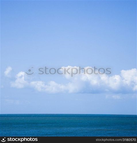 Ocean and sky with low cumulus clouds.