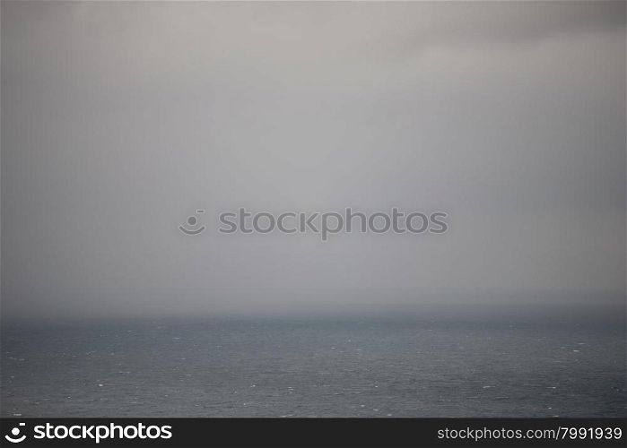 Ocean background with rain clouds. Ocean background with clouds and rain at the horizon