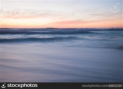 Ocean blurred waves. Stormy sunset seascape