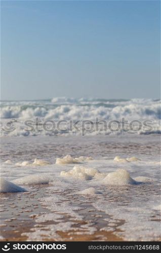 Ocean coast, moviment waves with foam. Wind power. Turquoise water.