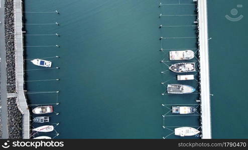 Ocean fishing trawlers docked in a calm bay after early morning fishing, unpacked and moored on a jetty on the Mornington Peninsula, Victoria, Australia