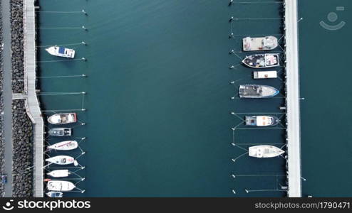 Ocean fishing trawlers docked in a calm bay after early morning fishing, unpacked and moored on a jetty on the Mornington Peninsula, Victoria, Australia