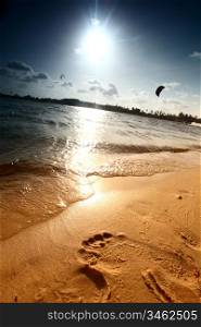 ocean footprints on sand near water