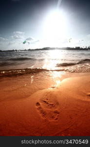 ocean footprints on sand near water