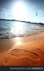 ocean footprints on sand near water