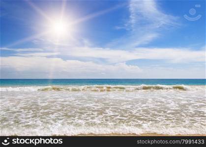 ocean, sandy beach and blue sky