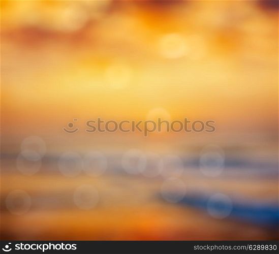 Ocean sunrise on beach defocused background