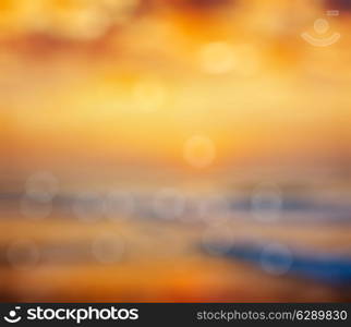 Ocean sunrise on beach defocused background