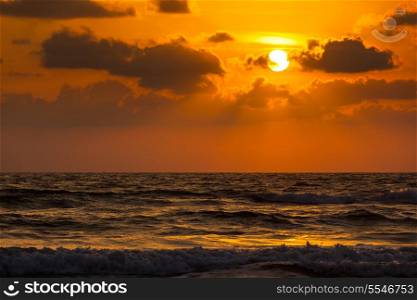Ocean sunset concept background. Baga beach. Goa, India