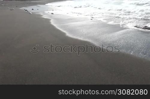 Ocean waves and beach with black volcanic sand, Canary Islands, Fuerteventura, Spain