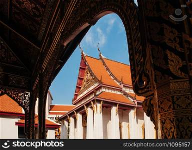 OCT 24, 2019 Bangkok, Thailand - Bangkok National Museum Front palace Buddaisawan throne hall seen through golden Thai pavillion gate frame