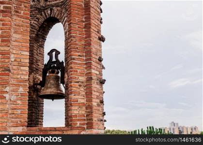 OCT 26, 2012 Barcelona, Spain - Red brick bell tower of Church of Colonia Guell or Gaudi Crypt in La Colonia Guell near Gaudi Crypt. Design by Antoni Gaudi