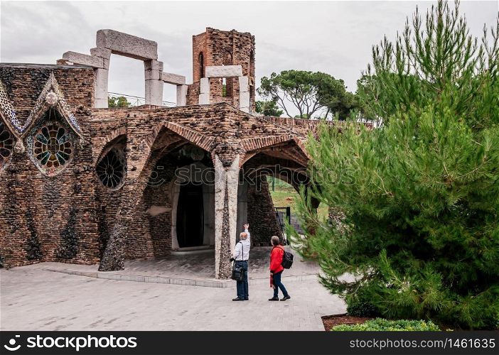 OCT 26, 2012 Barcelona, Spain - Tourists at unfinished vintage Church of Colonia Guell or Gaudi Crypt in La Colonia Guell near Gaudi Crypt. Design by Antoni Gaudi