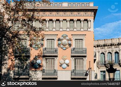 OCT 27, 2012 Bearcelona, Spain - Old Classic buildings on La Rambla street under warm beautiful sunlight in afternoon.