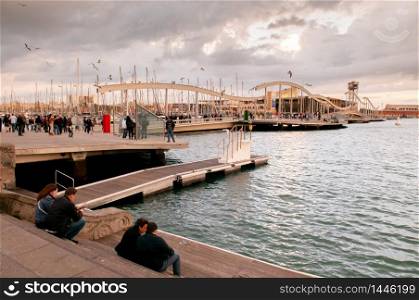 OCT 27, 2012 Bearcelona, Spain - Tourists enjoy evening view at Port of Barcelona or Port de Barcelona.
