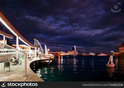 OCT 27, 2012 Bearcelona, Spain - Tourists family enjoy evening twilight view at Port of Barcelona or Port de Barcelona.
