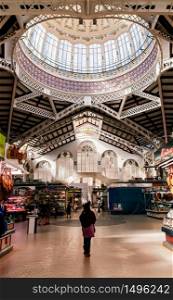 OCT 29, 2012 Valencia, Spain - Fresh produce shops and people in Valencia Central Market or Mercat Central. Builted in 1914 Valencian Art Nouveau style architecture, one of the largest market in Europe.