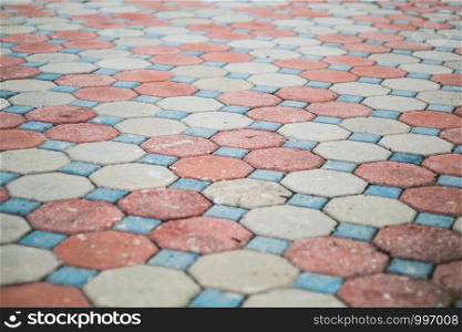 Octagon and square shape cement block pavement in random color pattern, selective focus.