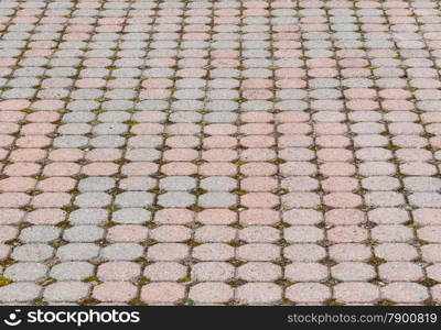 Octagonal paving stones pattern in perspective with gravel and grass in spaces.