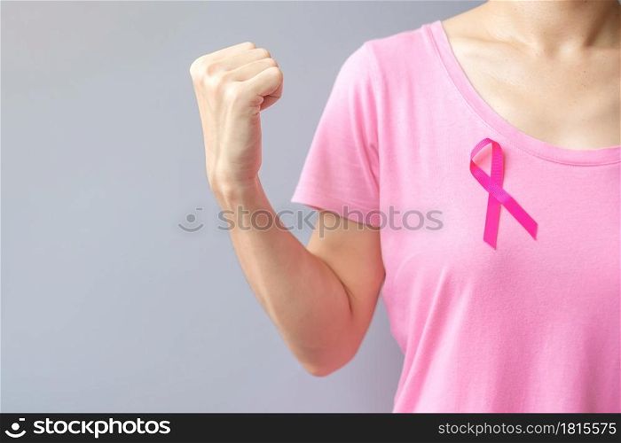 October Breast Cancer Awareness month, elderly Woman in pink T- shirt with Pink Ribbon and fist sign for supporting people living and illness. International Women, Mother and World cancer day concept