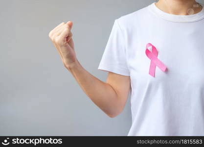 October Breast Cancer Awareness month, elderly Woman in white T- shirt with Pink Ribbon and fist sign for supporting people living and illness. International Women, Mother and World cancer day concept