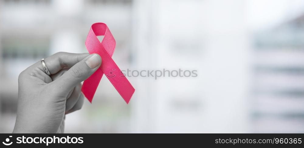 October Breast Cancer Awareness month, Woman holding Pink Ribbon for supporting people living and illness. Healthcare, International women day and World cancer day concept