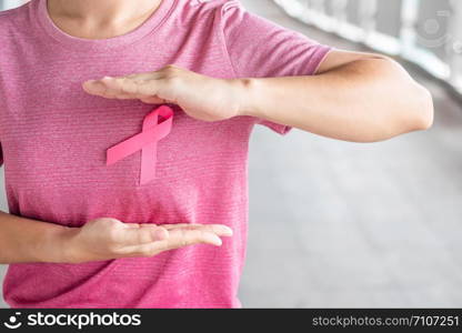 October Breast Cancer Awareness month, Woman in pink T- shirt with Pink Ribbon for supporting people living and illness. Healthcare, International women day and World cancer day concept