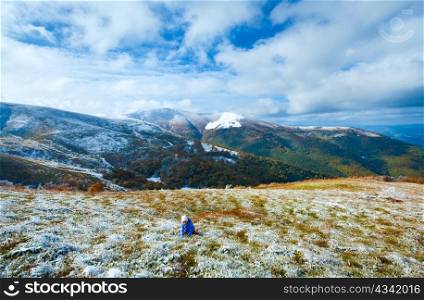 October Carpathian mountain Borghava plateau with first winter snow and playing girl on walk