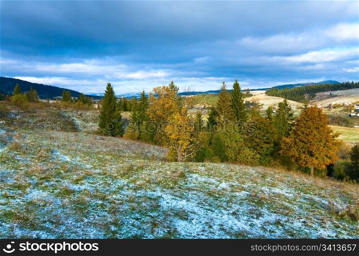 October Carpathian mountain plateau with first winter snow and autumn colorful foliage