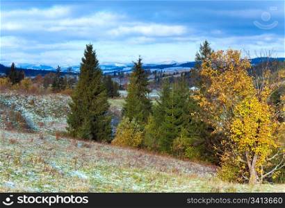 October Carpathian mountain plateau with first winter snow and autumn colorful foliage