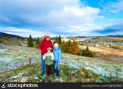 October Carpathian mountain plateau with first winter snow and autumn colourful foliage (and mother with children)