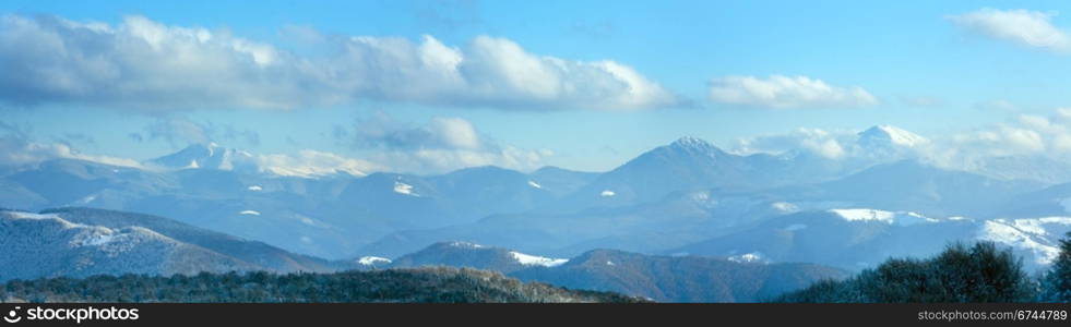 October misty mountain panorama with first winter snow. Three shots stitch image.