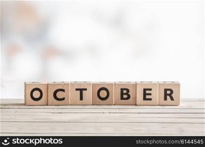 October sign made of wooden cubes on a desk