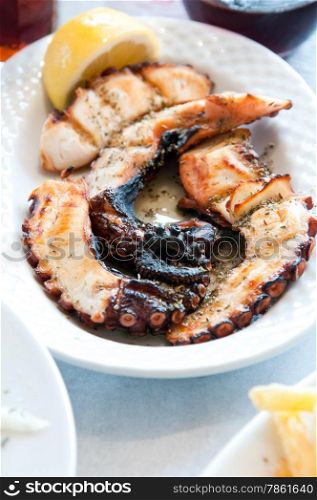 octopus grilled meat on a white plate