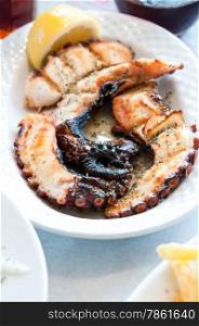 octopus grilled meat on a white plate
