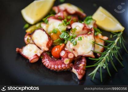 Octopus salad with lemon tomatoes rosemary and vegetables on plate, Fresh and healthy salad seafood squid and octopus