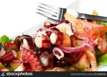 octopus salad with tomatoes, olives and red onion