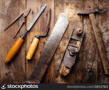 Od vintage hand tools on wooden background. Carpenter workplace