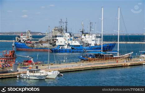 Odessa, Ukraine - 04.20.2019. View of the harbor and piers with parking for private yachts in the Odessa seaport on a sunny spring day. Private yachts in Odessa seaport