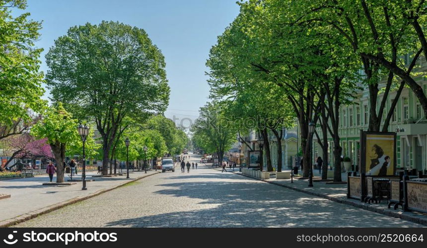 Odessa, Ukraine 06.05.2022. Deribasovskaya street near the City garden in Odessa during the war in Ukraine on a sunny spring day. Deribasovskaya street near the City garden of Odessa, Ukraine