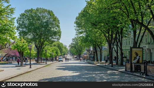 Odessa, Ukraine 06.05.2022. Deribasovskaya street near the City garden in Odessa during the war in Ukraine on a sunny spring day. Deribasovskaya street near the City garden of Odessa, Ukraine