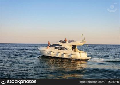 Odessa, Ukraine - September 04, 2016: Luxury white motor yacht under way out at the Black Sea. Summer evening.