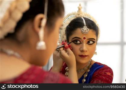 Odissi dancer doing make up
