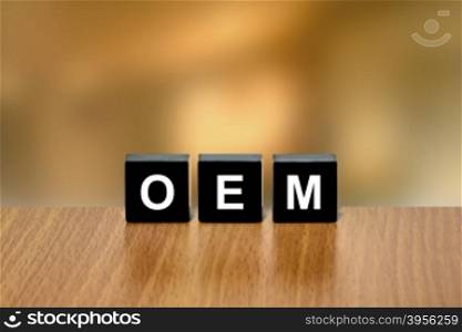 OEM or Original Equipment Manufacturer on black block with blurred background