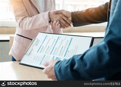 of successful business team shaking hands with eachother in the office, job interview concept.