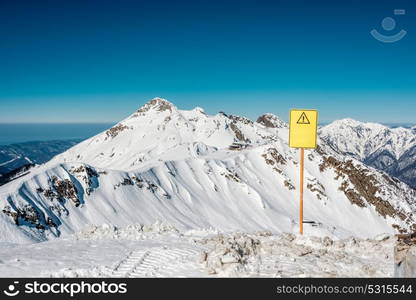 Off-piste sign. Winter mountain landscape. Caucasus ridge covered with snow in sunny day. Krasnaya Polyana, Sochi, Russia