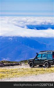 Off road vehicle above clouds in mountain nature, Portugal.. Off road vehicle in mountains above clouds