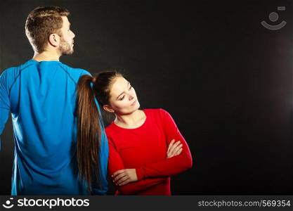 Offended upset young couple not talking to each other standing back to back after argument quarrel. Unhappy man and woman. Disagreement in relationship.. Offended couple back to back after argument.