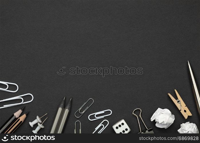 Office accessories on black paper background. Minimal style. Copy space. Top view